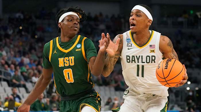 Baylor guard James Akinjo (11) drives against Norfolk State guard Christian Ings (0) during the first half of a college basketball game in the first round of the NCAA tournament in Fort Worth, Texas, Thursday, March 17, 2022.